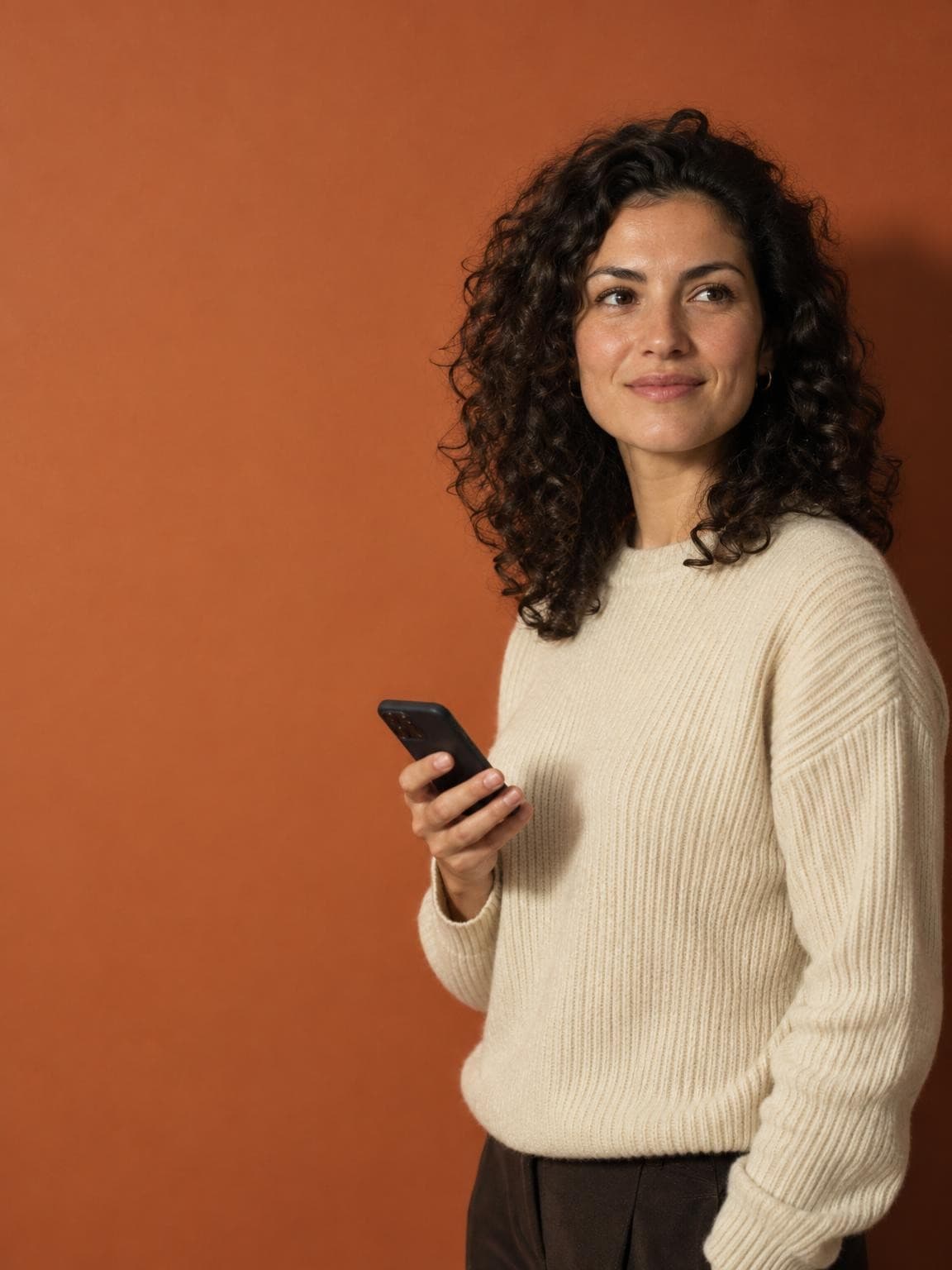 A creator with her phone in hand while Ignix answers her Instagram DMs on its own