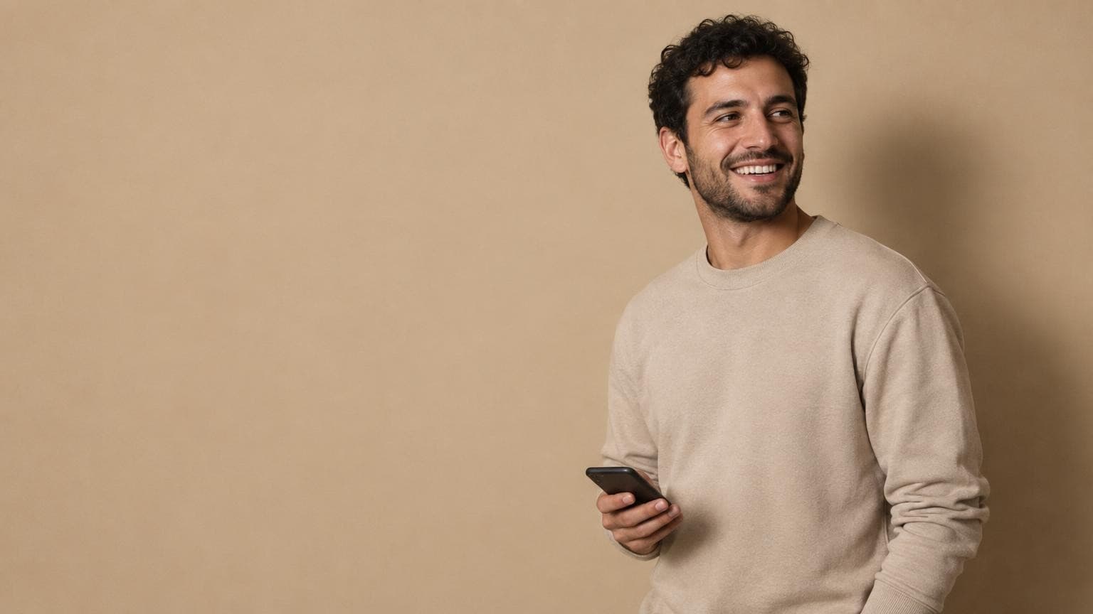 A creator laughing, phone in hand, with his DMs already handled