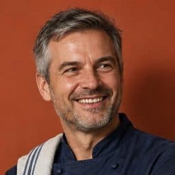 A restaurant owner with his arms crossed, bookings already taken care of