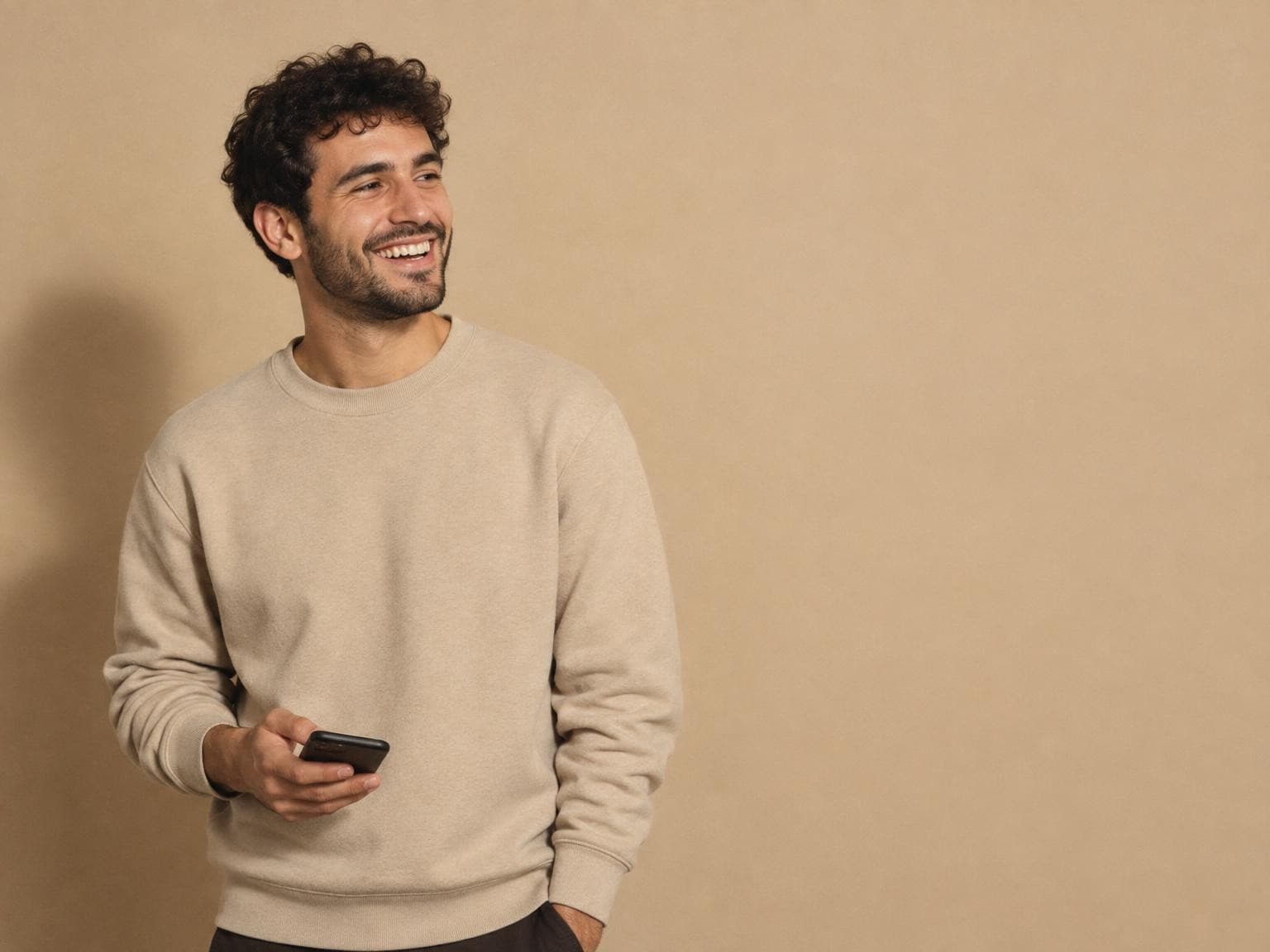 A creator laughing with his phone in hand while Ignix answers his DMs for him